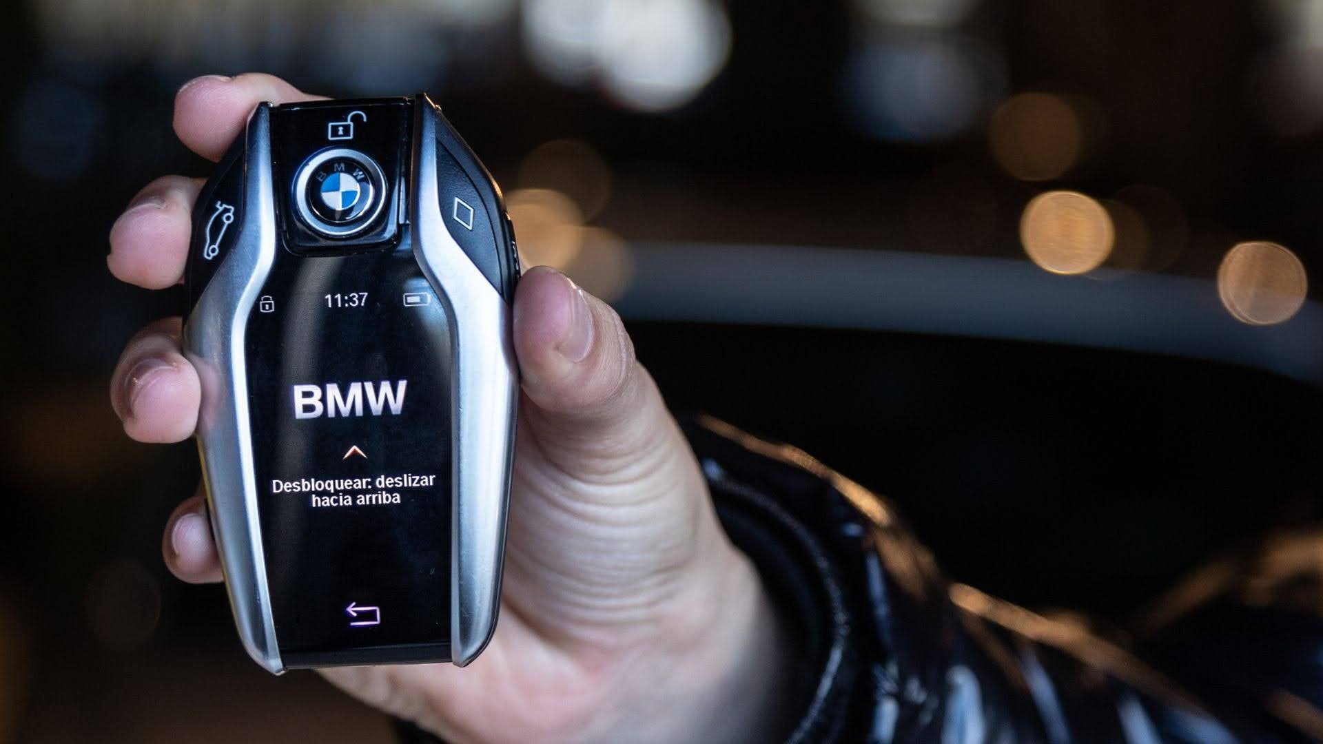 Person holding a black car key fob before purchase